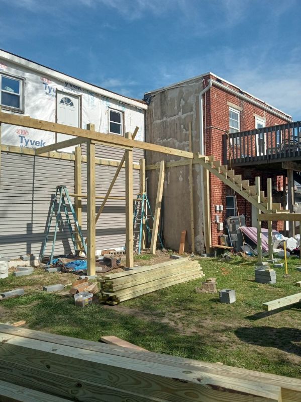 Lumber and new framing on a residential job site under a blue sky